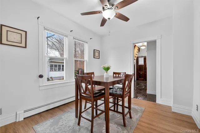 a view of a dining room with furniture and wooden floor