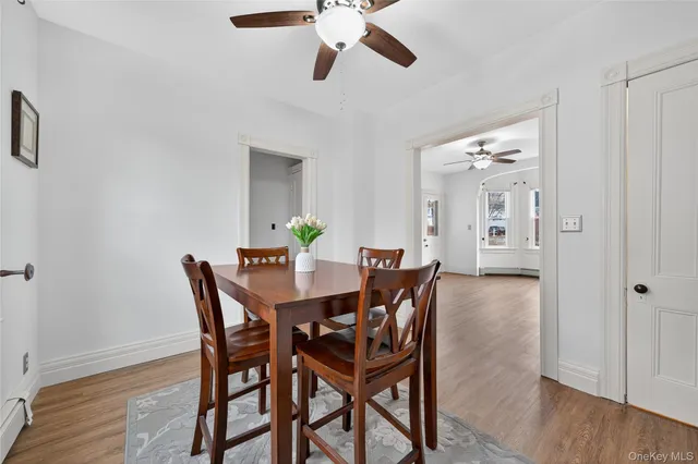 a view of a dining room with furniture and wooden floor