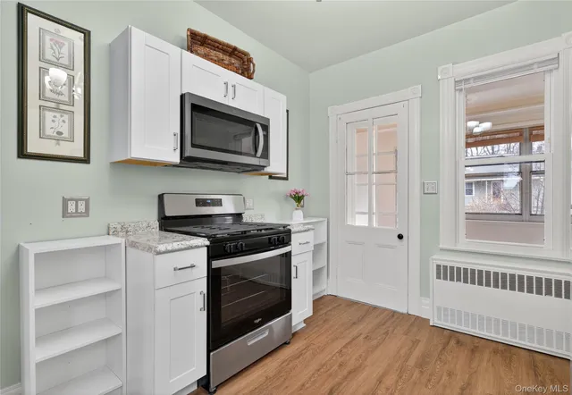 a kitchen with stainless steel appliances a stove microwave and a sink