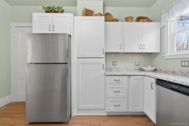 a kitchen with cabinets appliances and a window