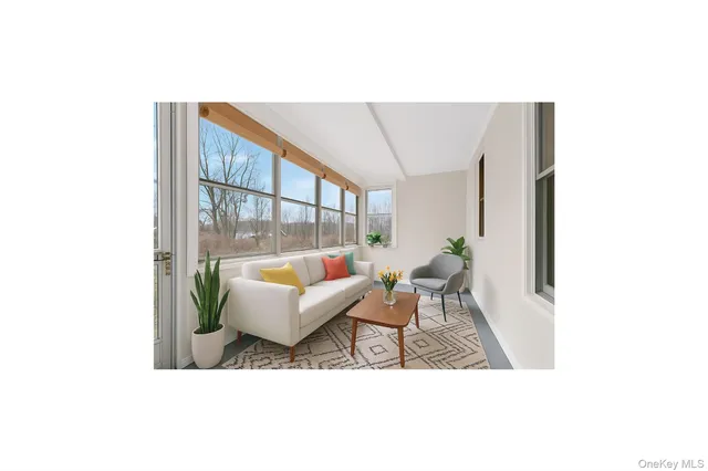 a living room with furniture and a potted plant