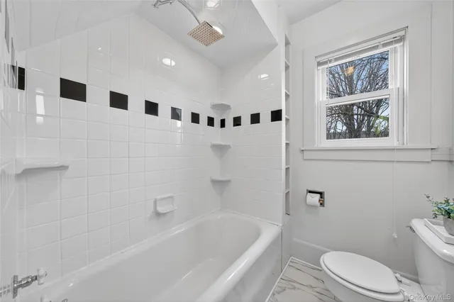 a bathroom with a toilet a sink and bathtub