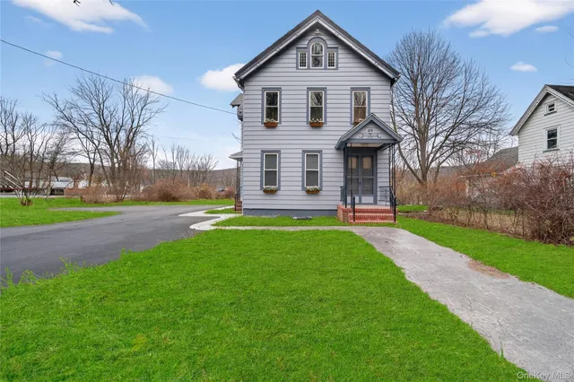 a front view of a house with a yard