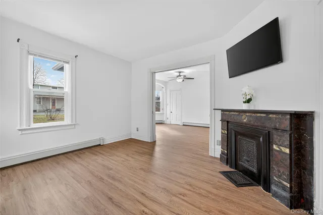 a view of a livingroom with wooden floor and a flat screen tv
