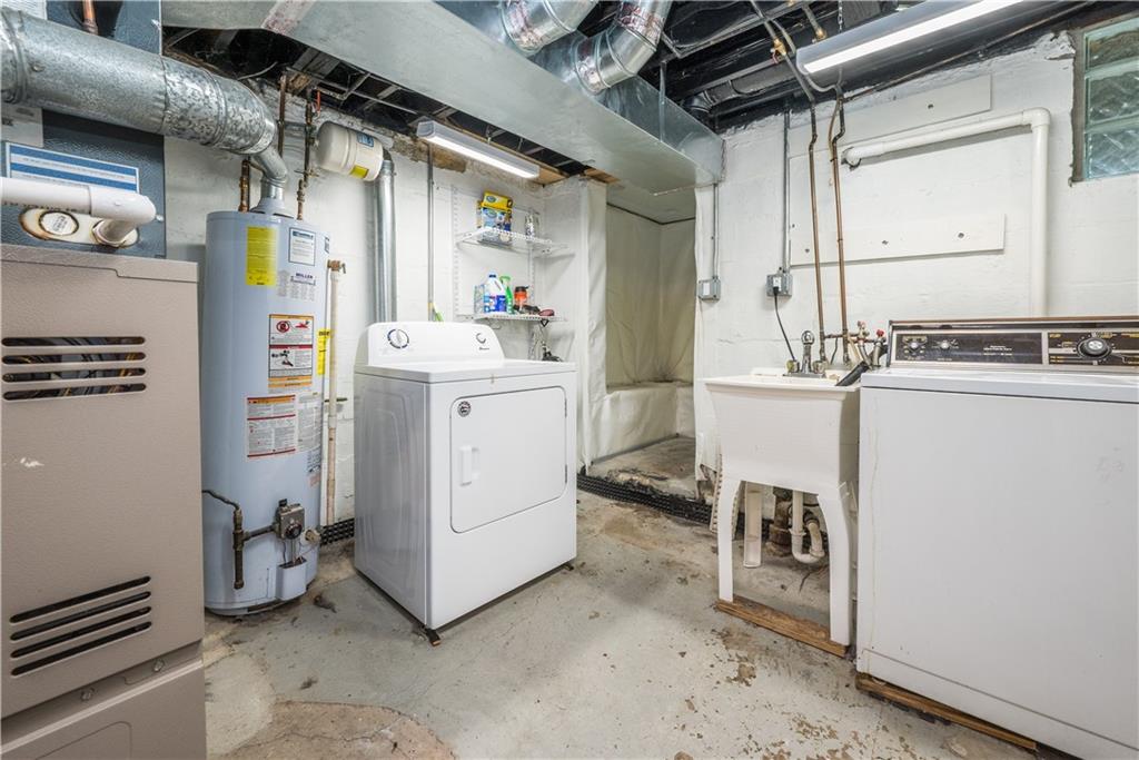 2138 Swallow Hill Road Pittsburgh, PA 15220 - Photo 22 of 29 a utility room with cabinets dryer and washer