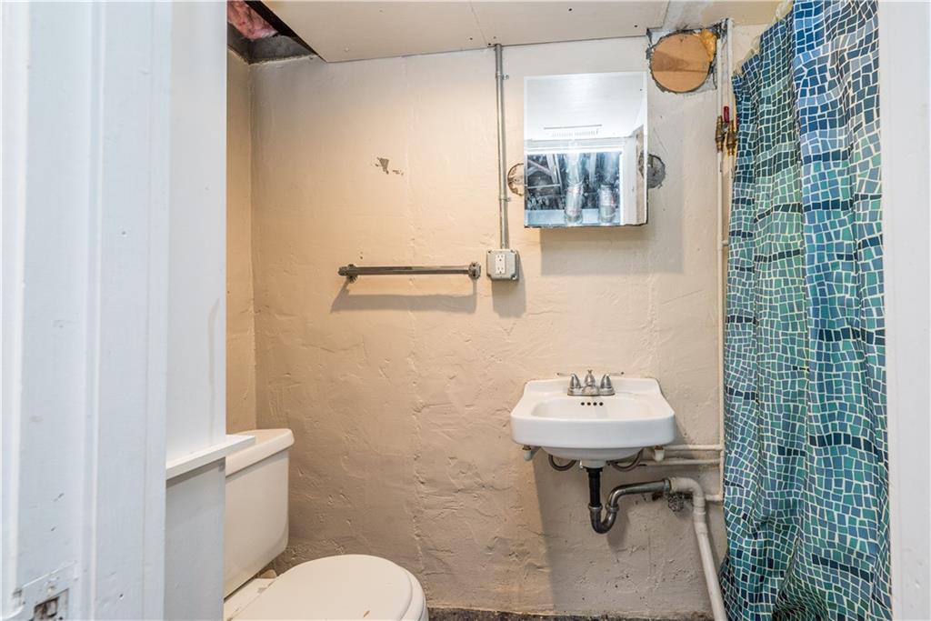 2138 Swallow Hill Road Pittsburgh, PA 15220 - Photo 23 of 29 a bathroom with a sink toilet and mirror