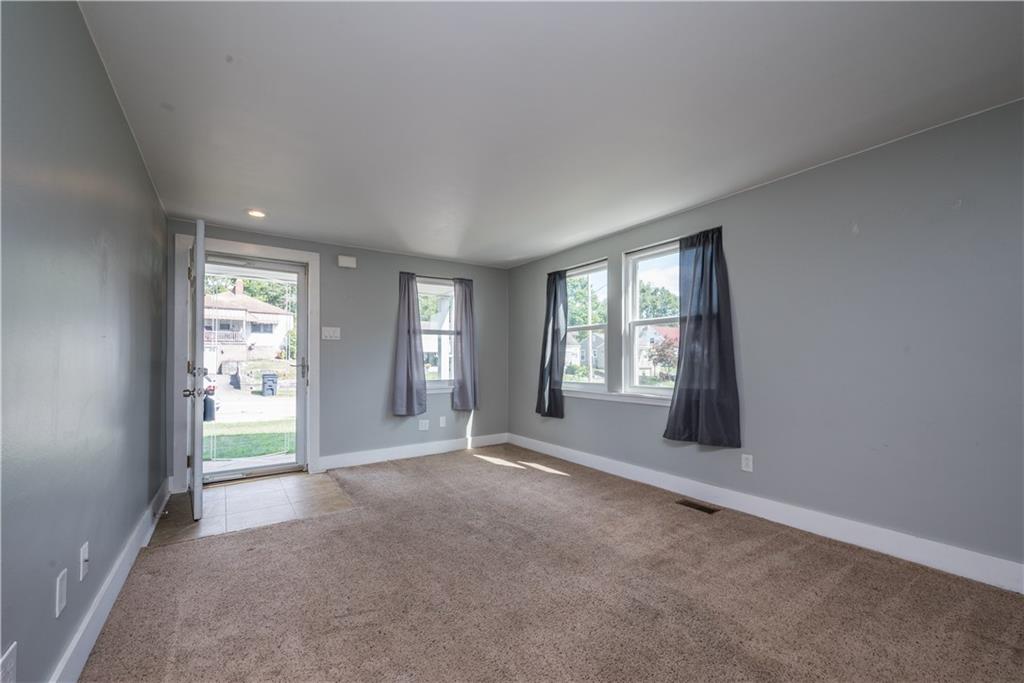 2138 Swallow Hill Road Pittsburgh, PA 15220 - Photo 7 of 29 a view of a big room with windows and chandelier fan