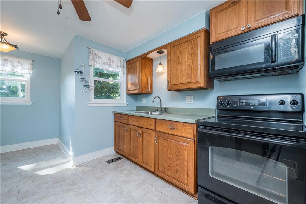 2138 Swallow Hill Road Pittsburgh, PA 15220 - Photo 10 of 29 a kitchen with granite countertop cabinets stove top oven and sink