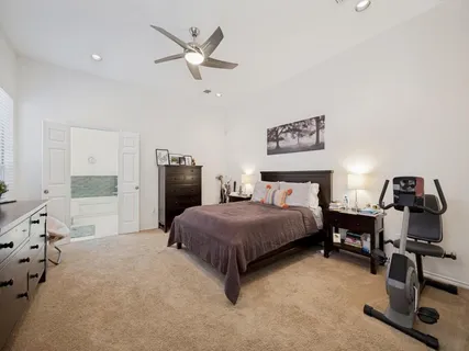 a spacious bedroom with a bed and a desk