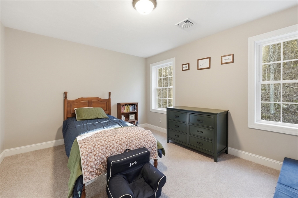 103 Rice Corner Road Brookfield, MA 01506 - Photo 29 of 39 a bedroom with a bed and a dresser