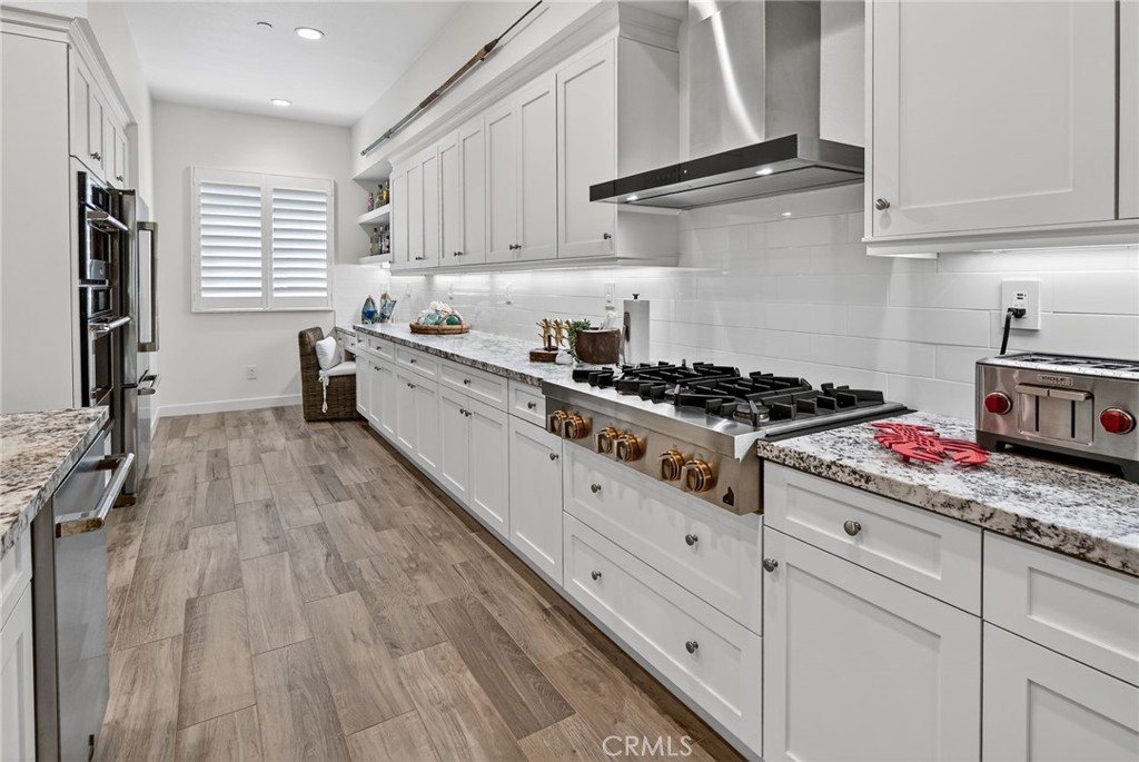 3446 Doheny Way Dana Point, CA 92629 - Photo 23 of 58 a kitchen with stainless steel appliances granite countertop a stove a sink and white cabinets