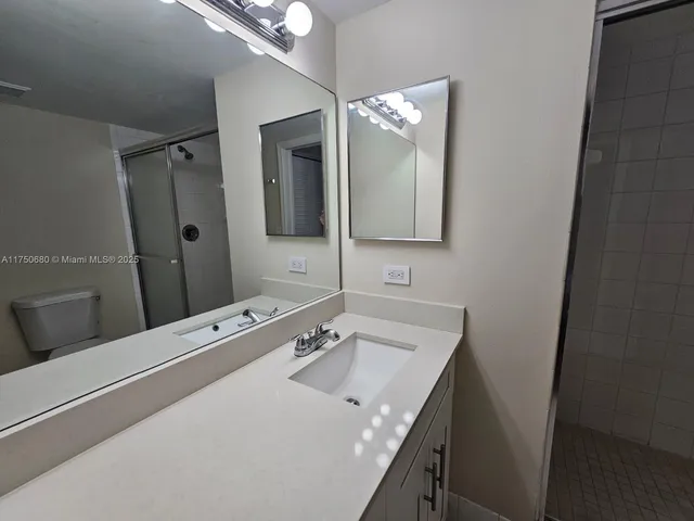 a bathroom with a sink vanity and mirror