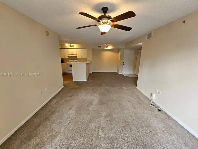 en empty room with a ceiling fan and a ceiling fan