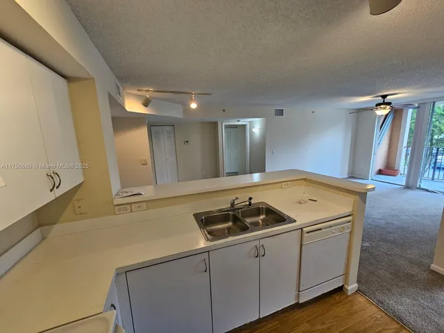 a kitchen that has a sink and a stove in it