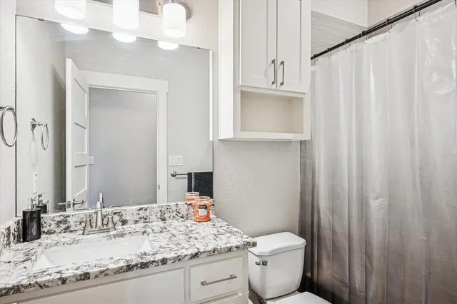 a utility room with stainless steel appliances cabinets and a window