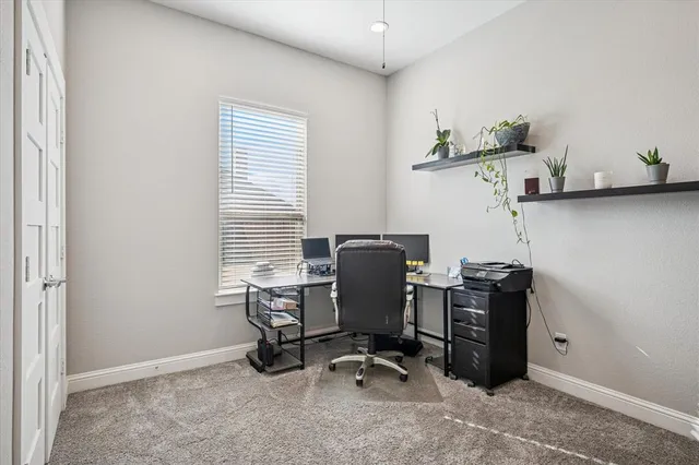 a workspace with furniture and a potted plant