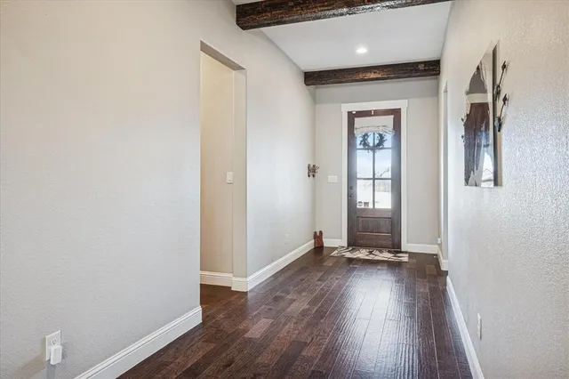 a view of a room with wooden floor and window