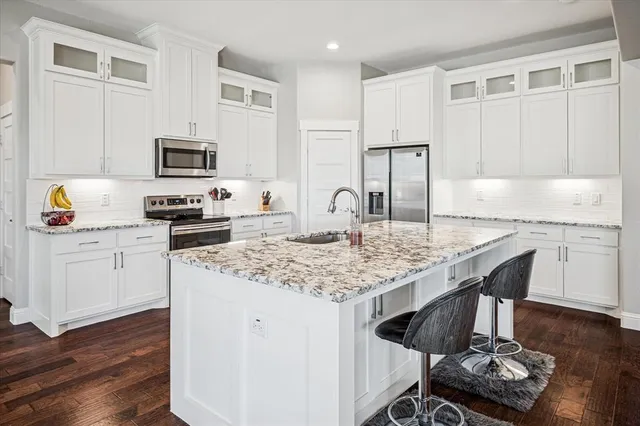 a kitchen with a sink stove and cabinets