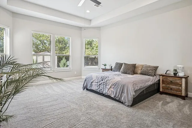 a spacious bedroom with a bed and a large window
