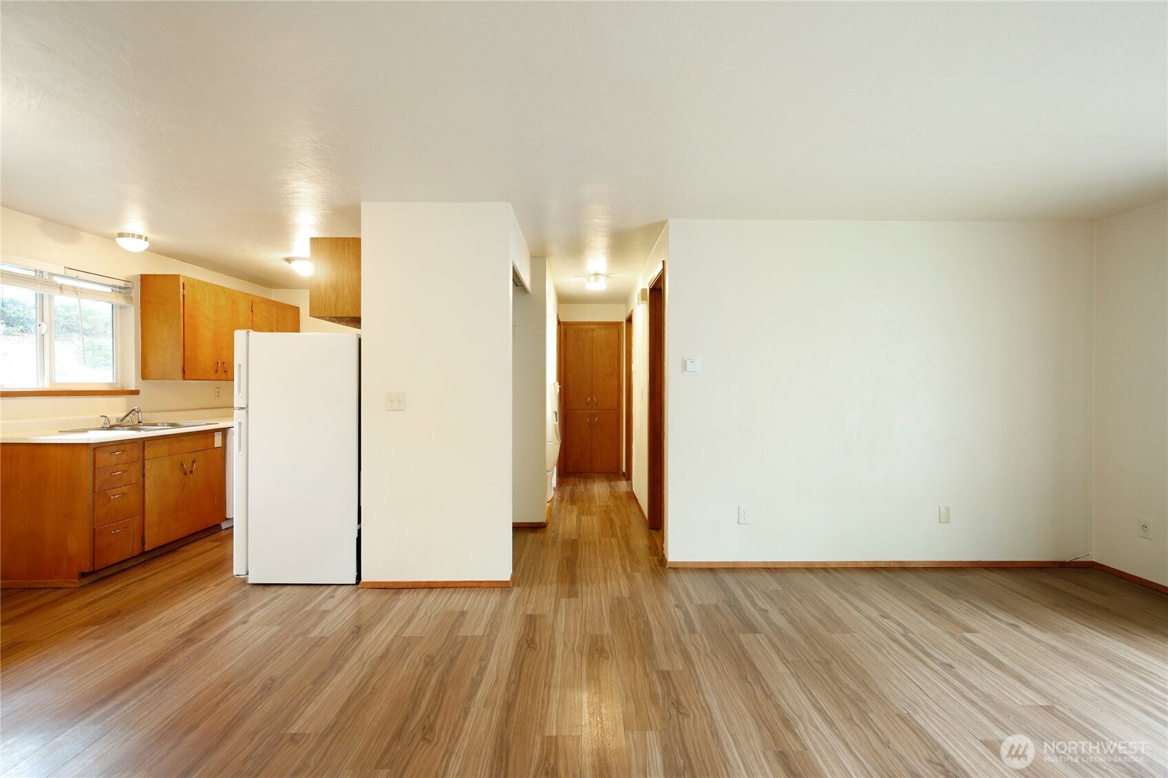1901 Northeast 30th Street Bremerton, WA 98310 - Photo 6 of 31 a view of a kitchen with wooden floor and white stainless steel appliances