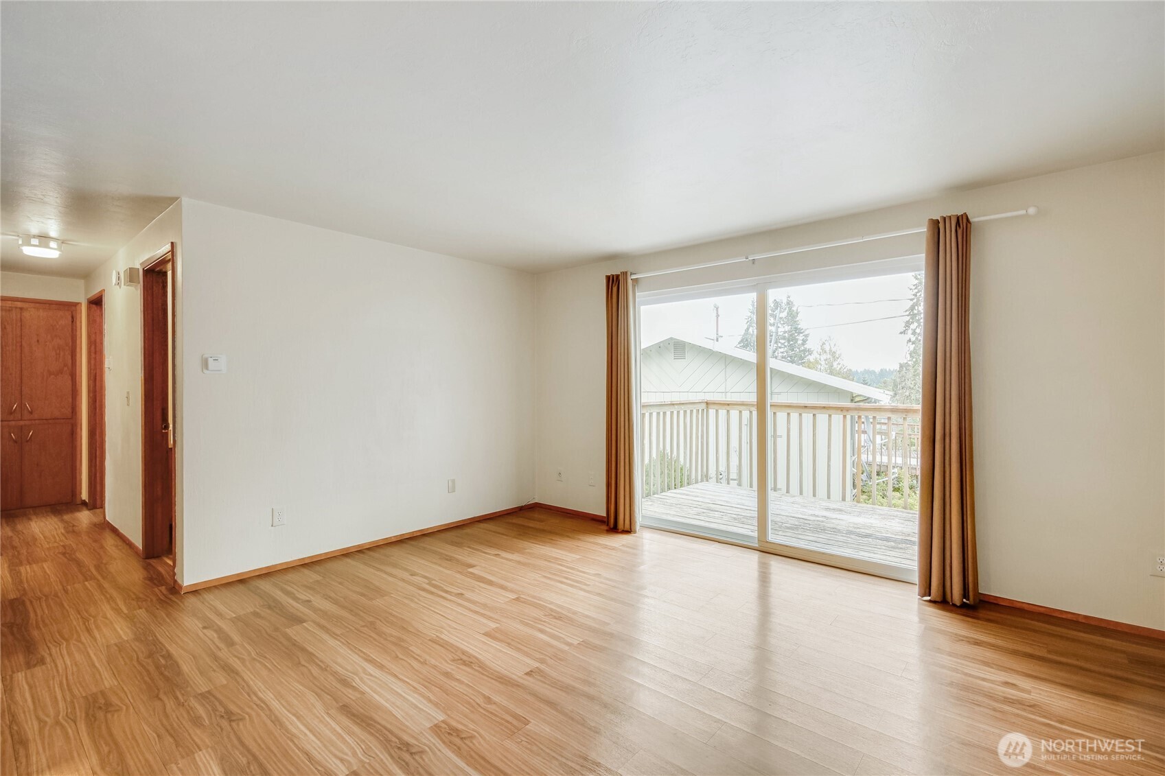 1901 Northeast 30th Street Bremerton, WA 98310 - Photo 7 of 31 a view of an empty room with wooden floor and a window