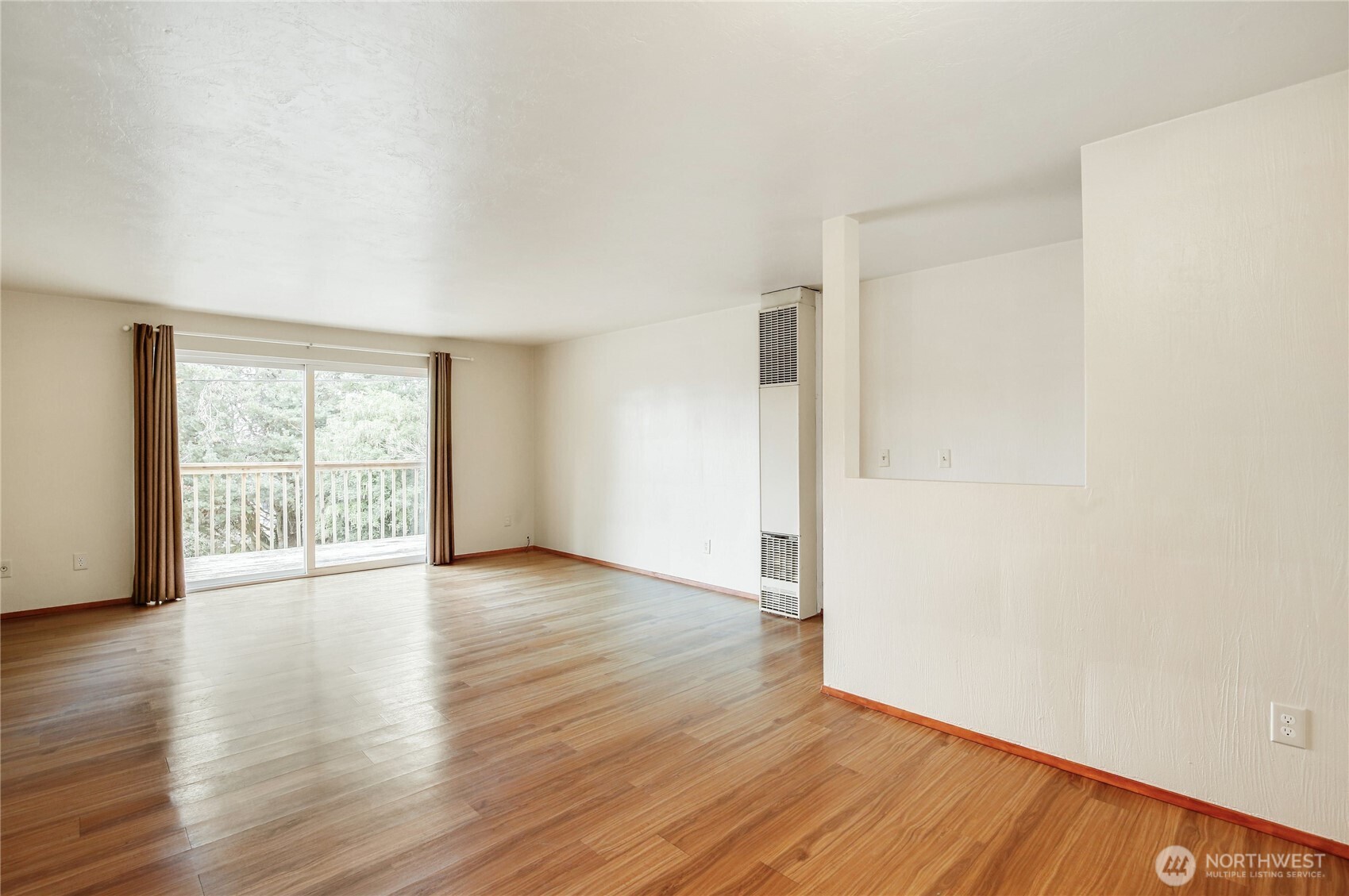 1901 Northeast 30th Street Bremerton, WA 98310 - Photo 8 of 31 a view of an empty room with wooden floor and a window