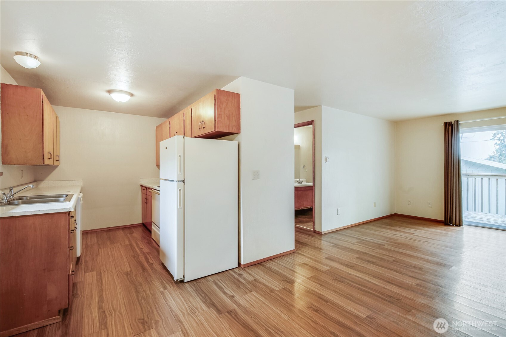 1901 Northeast 30th Street Bremerton, WA 98310 - Photo 9 of 31 a view of a kitchen with wooden floor electronic appliances and a window