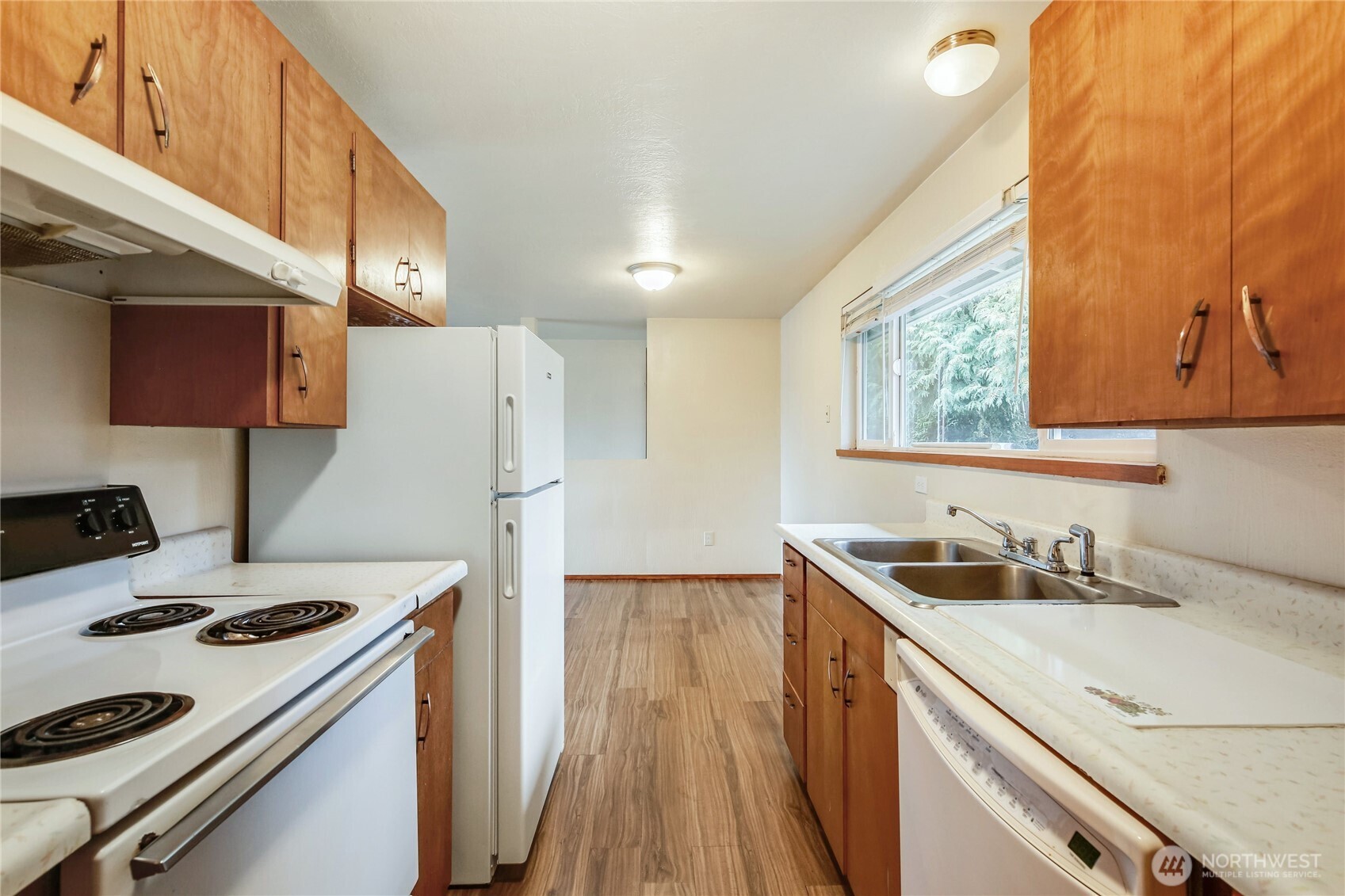 1901 Northeast 30th Street Bremerton, WA 98310 - Photo 10 of 31 a kitchen that has a sink a stove and a refrigerator