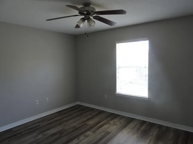 wooden floor in an empty room with a window