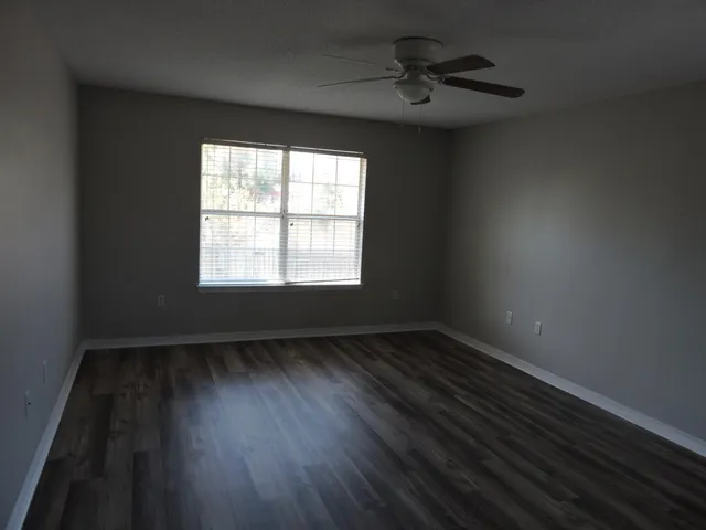 wooden floor in an empty room with a window