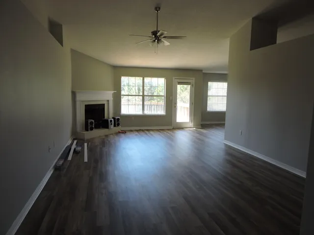 wooden floor in an empty room with a window