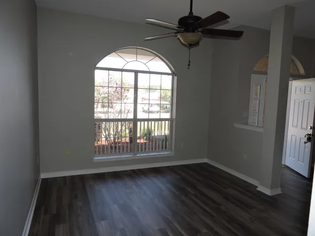 wooden floor in an empty room with a window