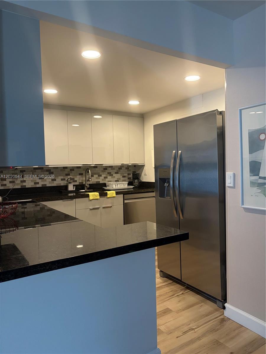 1913 South Ocean Drive, Unit 427 Hallandale Beach, FL 33009 - Photo 8 of 16 a kitchen with stainless steel appliances granite countertop a refrigerator a sink and a stove