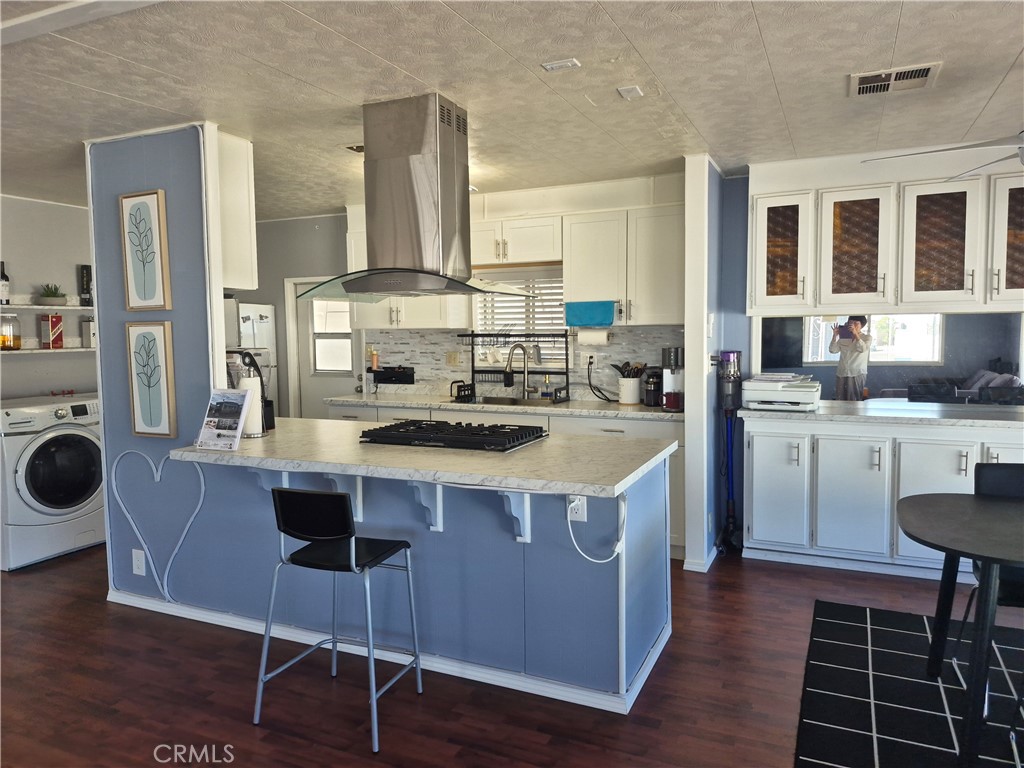 22 Magnolia Via Anaheim, CA 92801 - Photo 11 of 30 a kitchen with a stove a sink a dining table and chairs