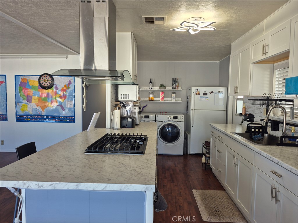 22 Magnolia Via Anaheim, CA 92801 - Photo 12 of 30 a kitchen with a refrigerator a stove and wooden floor