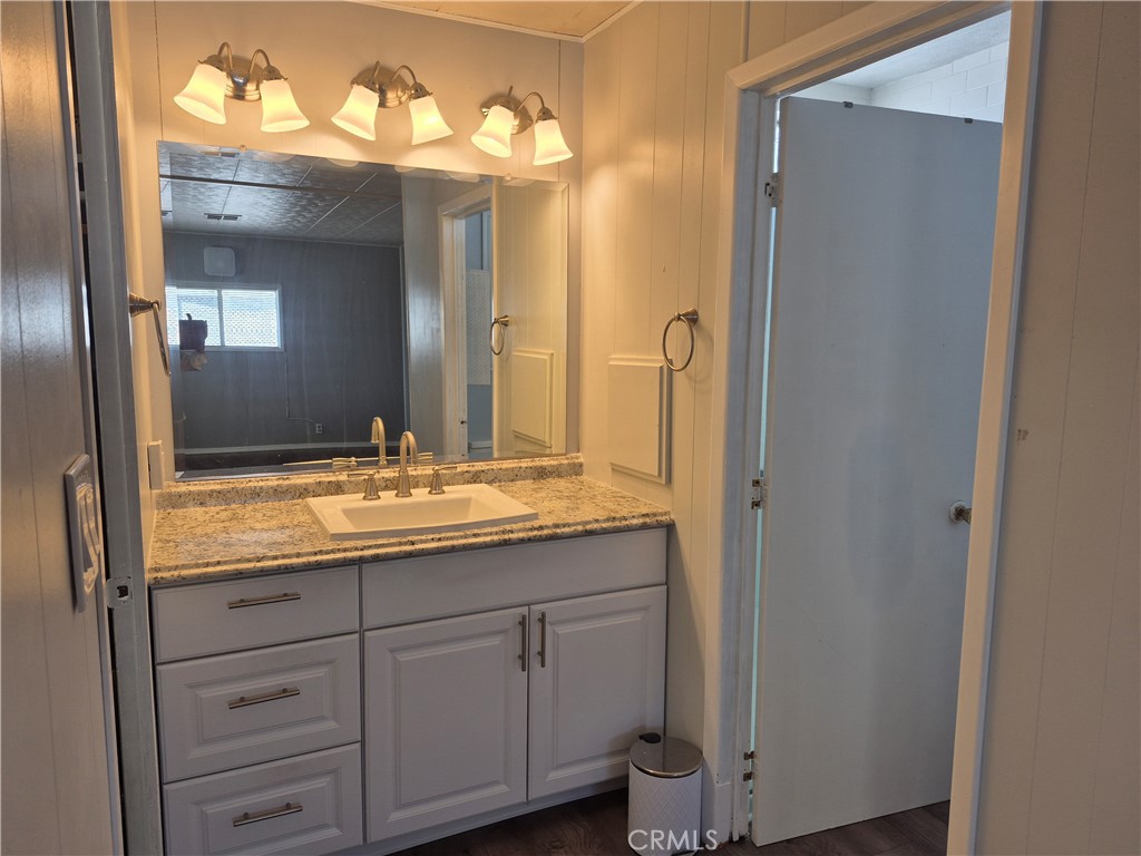 22 Magnolia Via Anaheim, CA 92801 - Photo 19 of 30 a bathroom with a granite countertop sink and a mirror