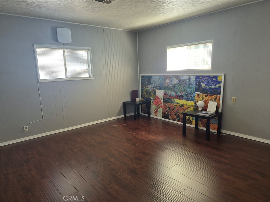 22 Magnolia Via Anaheim, CA 92801 - Photo 29 of 30 a view of a room with wooden floor a chair and windows
