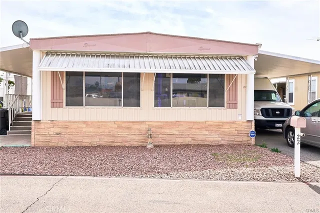 a kitchen with wooden cabinets a stove a sink and a stove with wooden floor