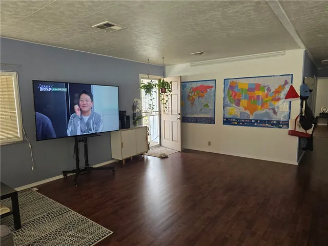 a bathroom with a granite countertop sink a toilet and mirror