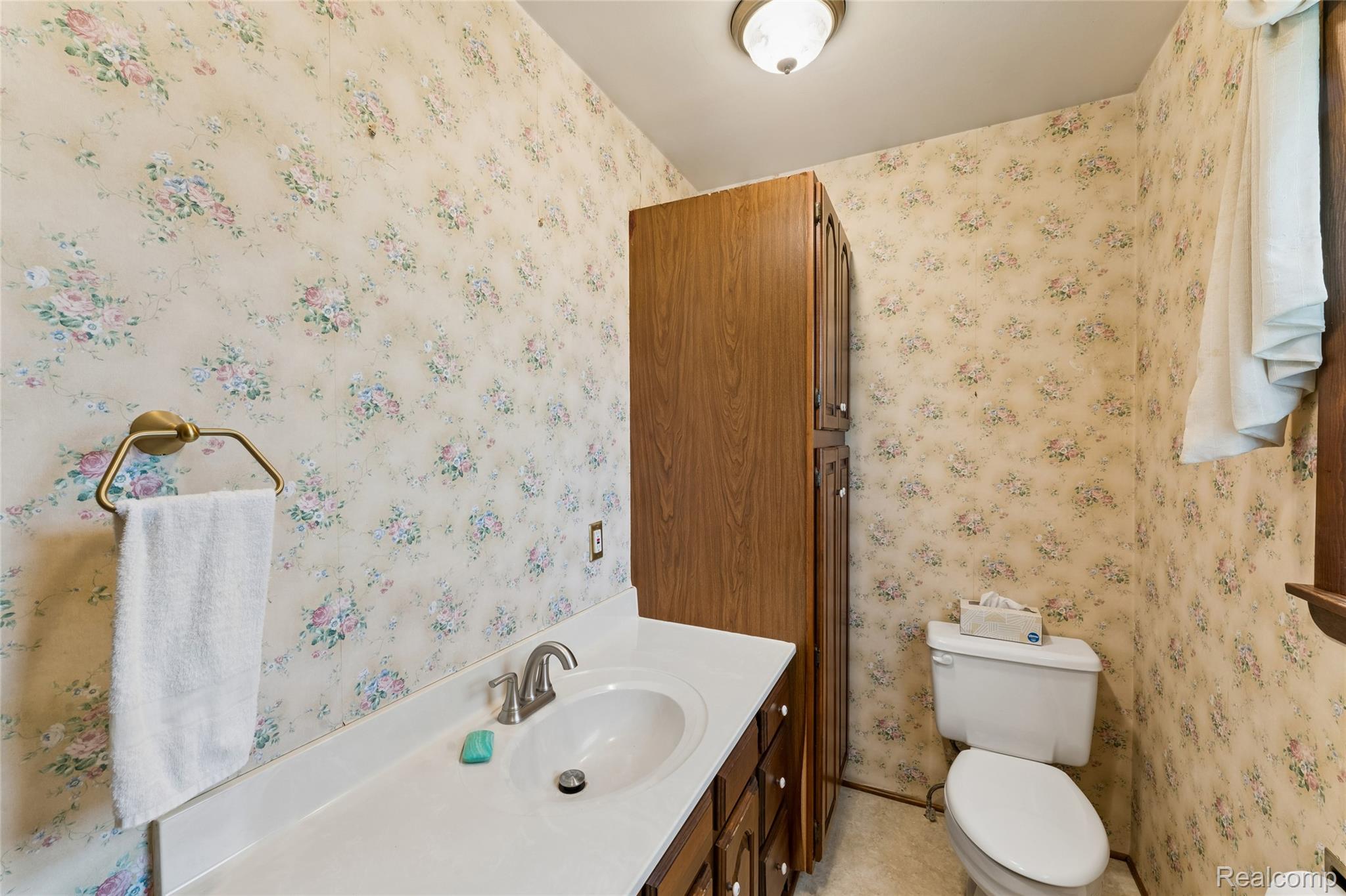 422 East Road Holly, MI 48442 - Photo 30 of 51 Bathroom featuring a vanity with an integrated sink, brushed nickel faucet, and wood-finish cabinetry