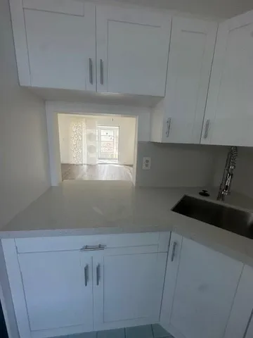 a kitchen with a cabinets and window