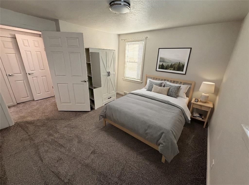 710 Locust Street, Unit 708 Bridgeville, PA 15017 - Photo 7 of 10 a bedroom with a bed and a painting on the wall