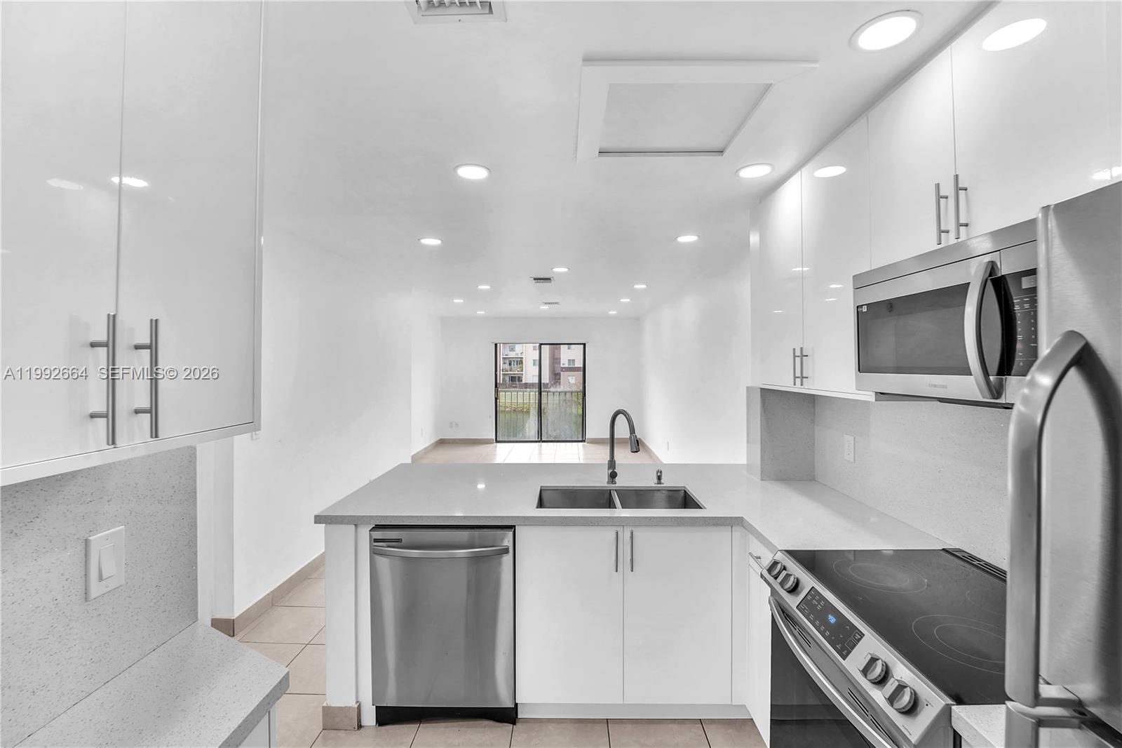 a kitchen with stainless steel appliances granite countertop a sink and a stove