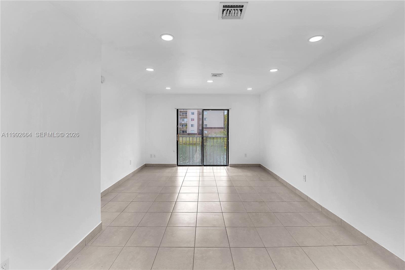 7668 Southwest 152nd Avenue, Unit 2211 Miami, FL 33193 - Photo 11 of 20 a view of an empty room with a window