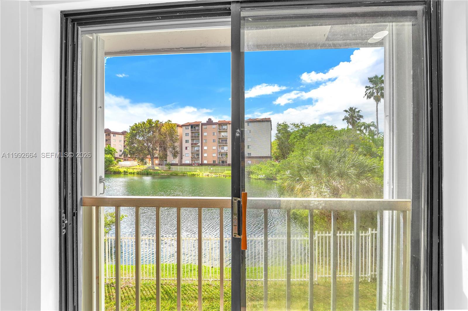 7668 Southwest 152nd Avenue, Unit 2211 Miami, FL 33193 - Photo 13 of 20 a view of a glass door with a from a window