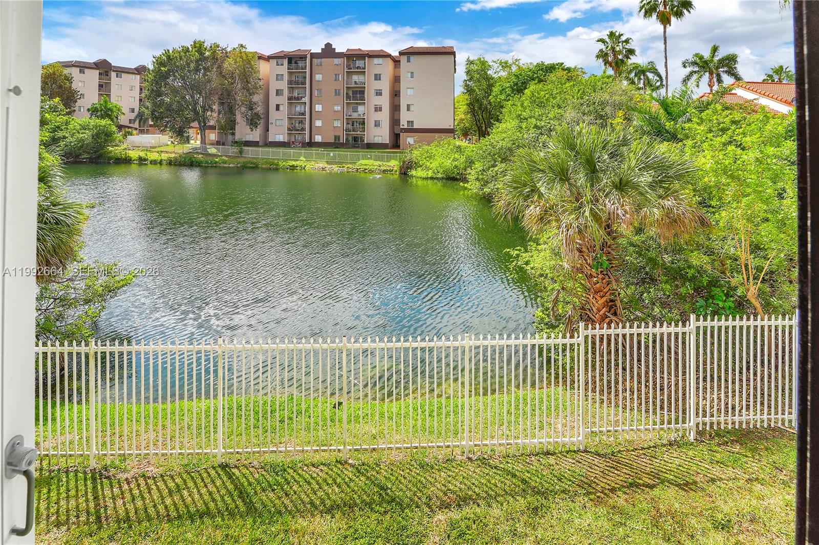 7668 Southwest 152nd Avenue, Unit 2211 Miami, FL 33193 - Photo 14 of 20 a view of a fence and a garden