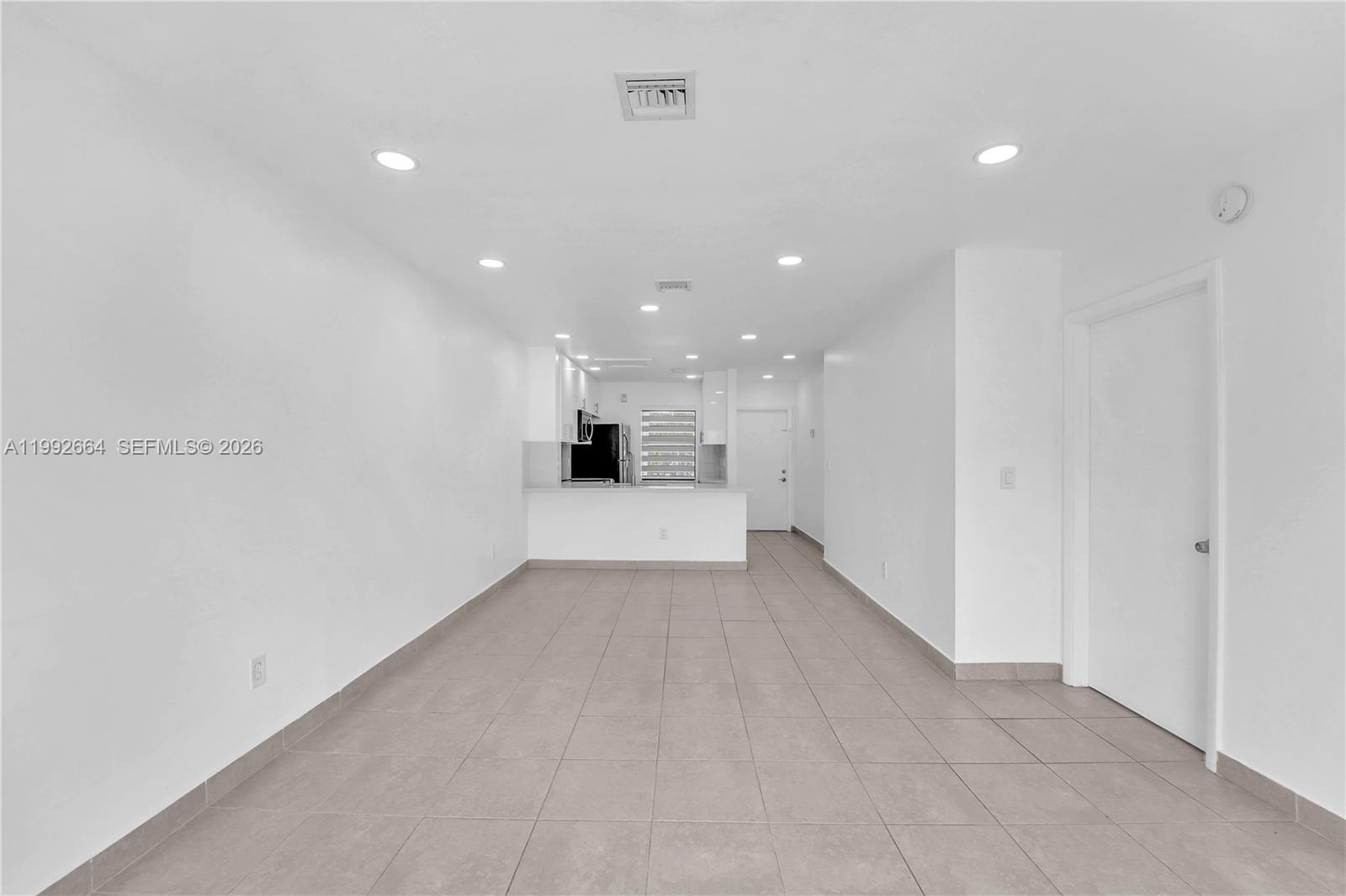7668 Southwest 152nd Avenue, Unit 2211 Miami, FL 33193 - Photo 15 of 20 a view of a hallway with a kitchen
