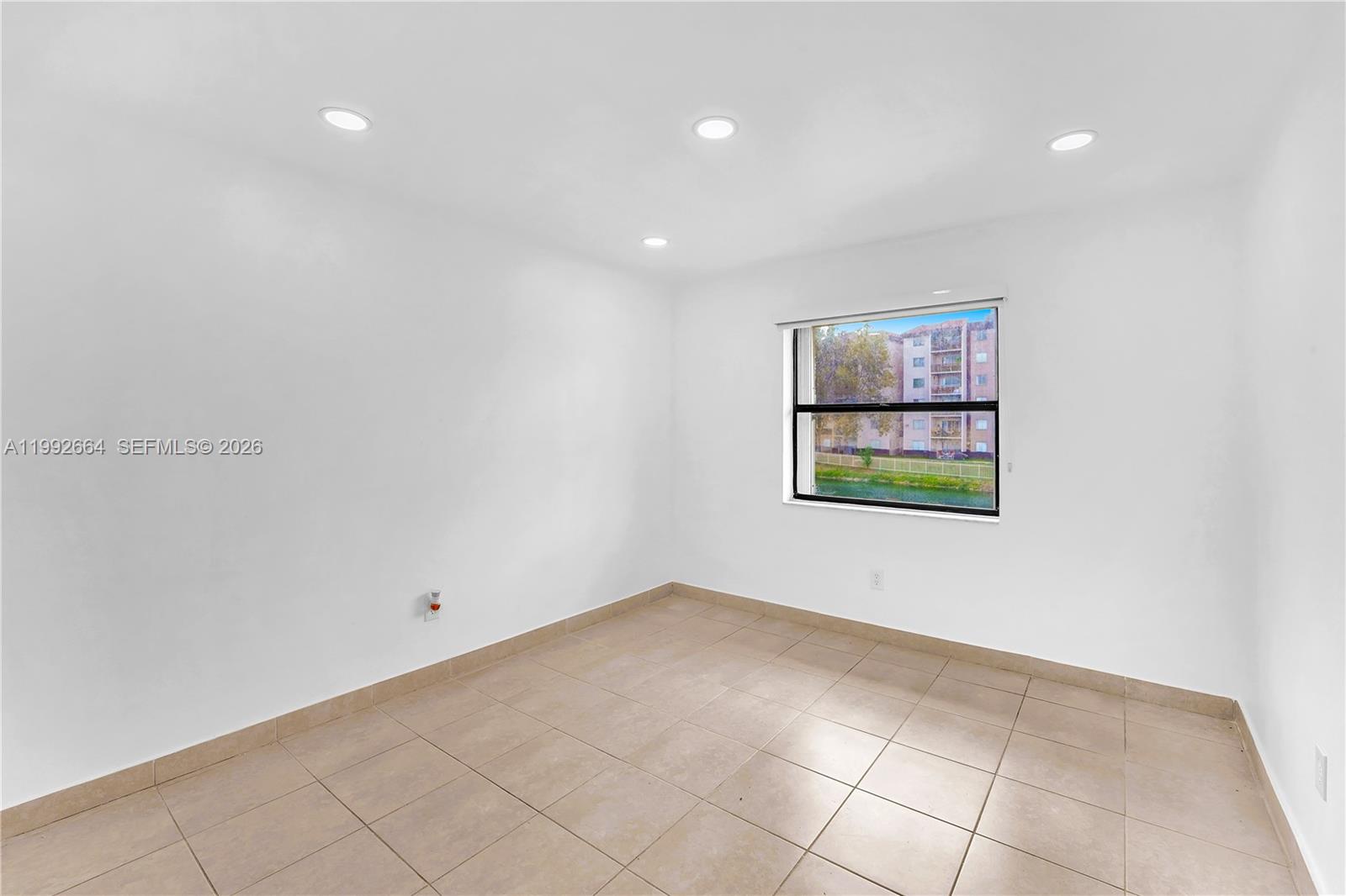 7668 Southwest 152nd Avenue, Unit 2211 Miami, FL 33193 - Photo 16 of 20 a view of an empty room with a window