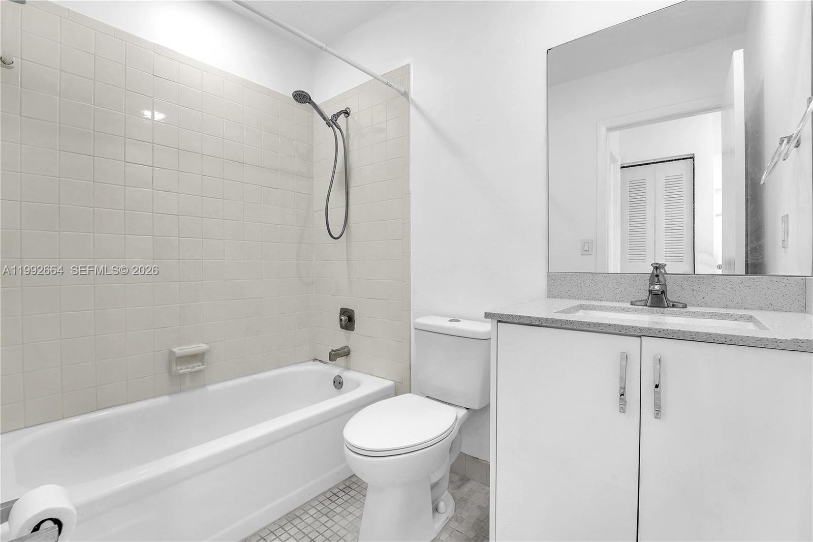 7668 Southwest 152nd Avenue, Unit 2211 Miami, FL 33193 - Photo 19 of 20 a bathroom with a sink a toilet and a bathtub