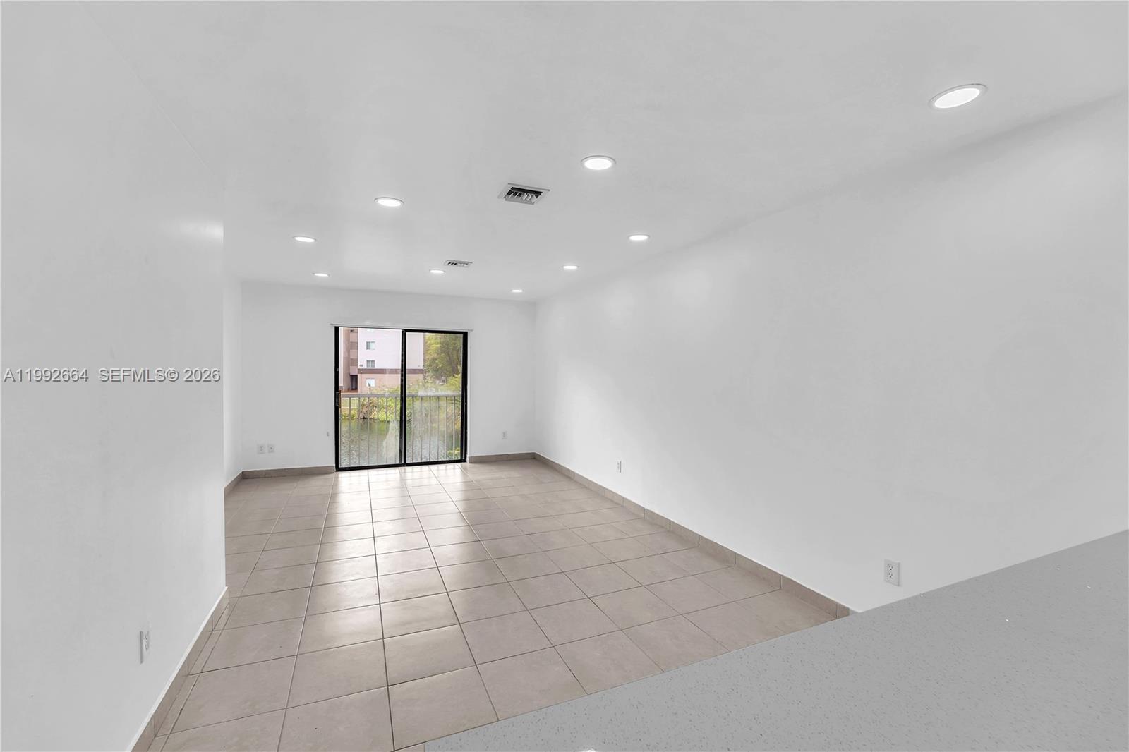 7668 Southwest 152nd Avenue, Unit 2211 Miami, FL 33193 - Photo 5 of 20 a view of an empty room with a window